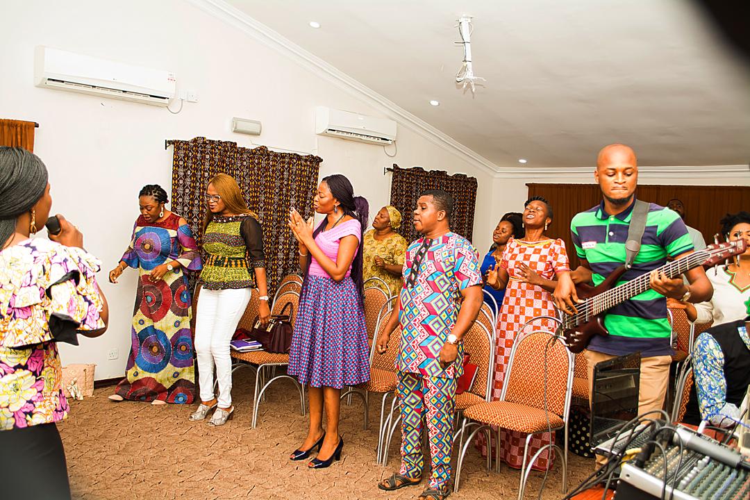 A couple joyfully holding their baby